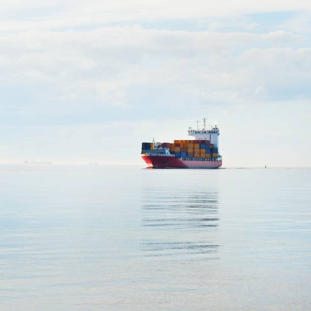 Large container ship sailing in still sea water