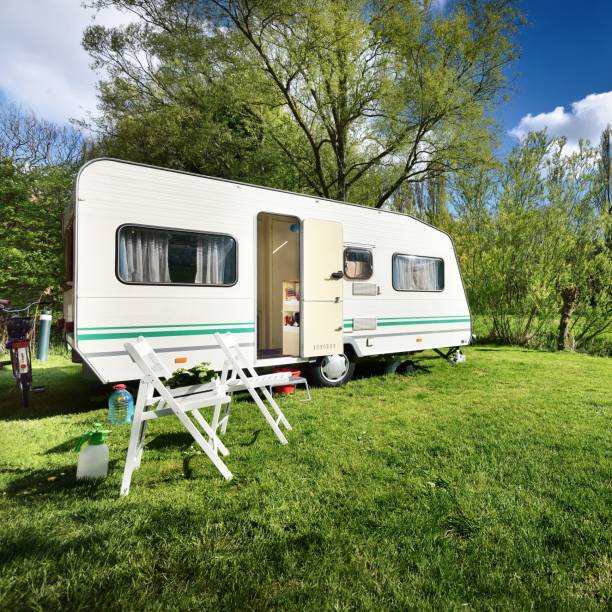 istock Caravan trailer on a green lawn, on a sunny spring day 1175769563