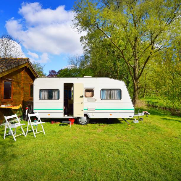 istock Caravan trailer on a green lawn, on a sunny spring day 1175769568