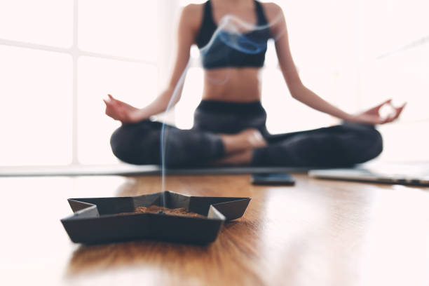 istock Woman doing yoga and burning scented sticks 1175769774