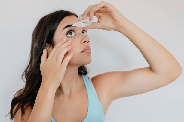 istock Closeup of eyedropper putting liquid into open eye 1175776607