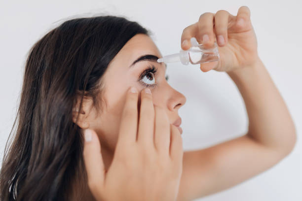 istock Closeup of eyedropper putting liquid into open eye 1175776624