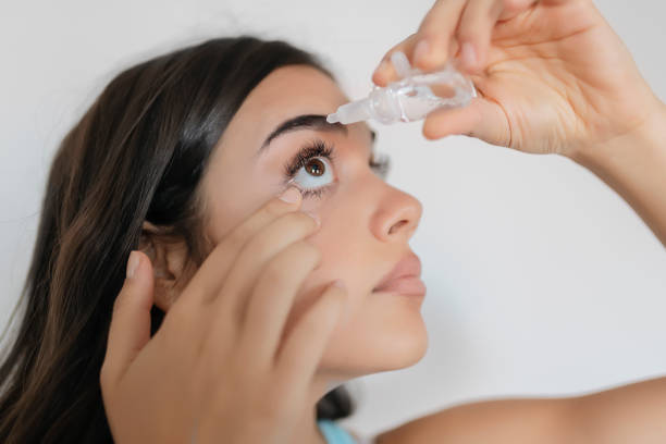 istock Closeup of eyedropper putting liquid into open eye 1175776626
