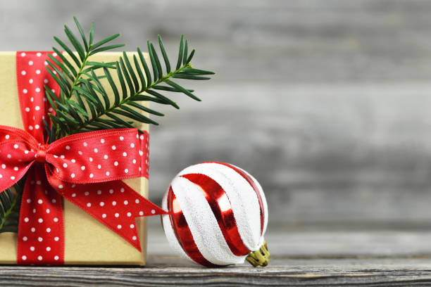 istock Christmas gift and bauble on wooden background 1175777158