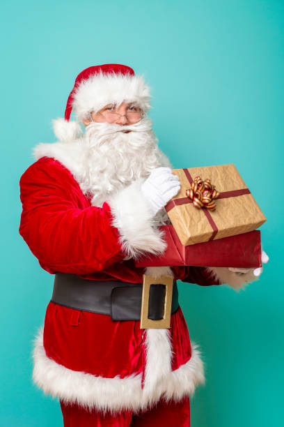 istock Santa Claus holding a gift box 1175778084