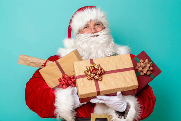 istock Santa holding pile of presents 1175778187