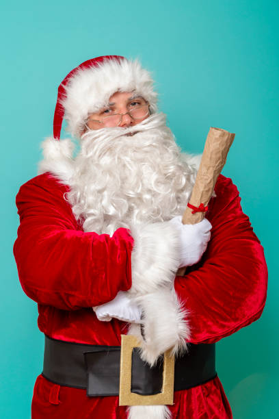istock Santa Claus holding a childrens wish list 1175778249
