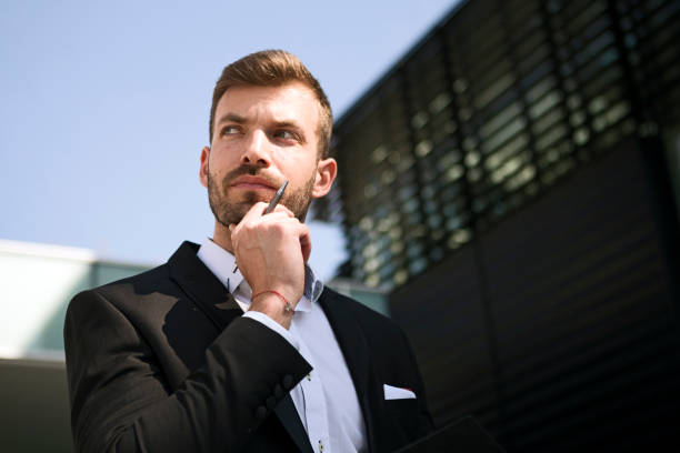 istock Pensive businessman in front of office 1175778987