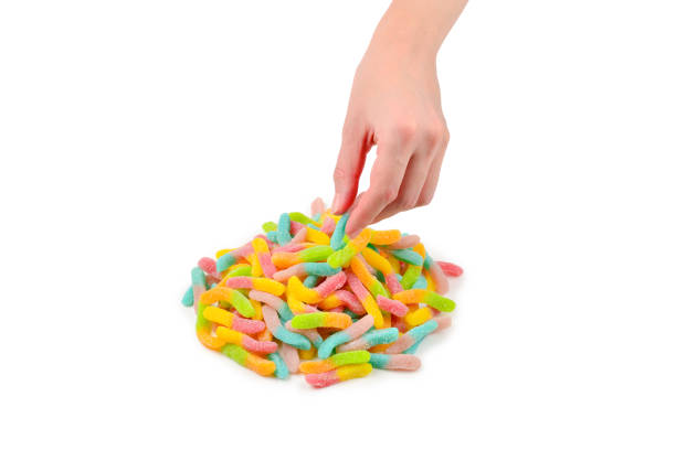 istock Female hand holding jelly sweets isolated on white background 1175779418