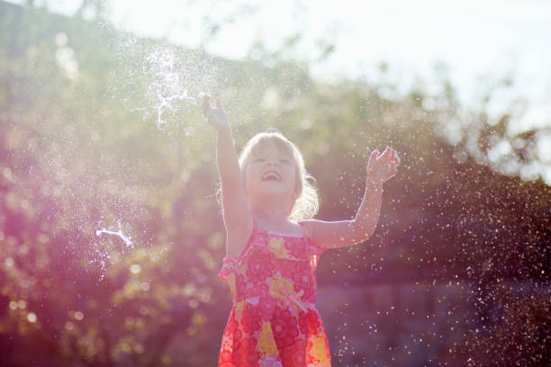 istock playful little girl hands up 1175779758