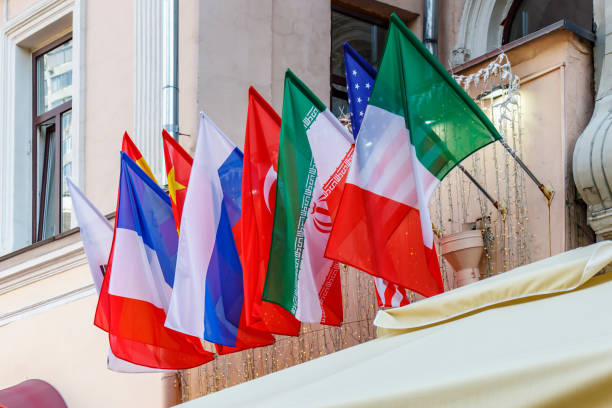 istock Waving flags of different countries in a row on the wall in sunlight 1175780703