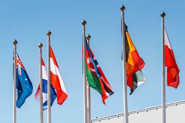 istock Flags of different countries against blue sky in sunny morning 1175780724