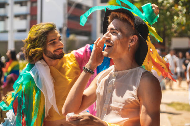 istock Gay man applying glitter on his face 1175786624