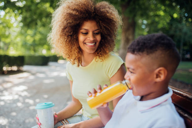 istock Mother and son having drinks in the park 1175788696