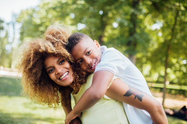 istock Mother carrying son on her back 1175789209
