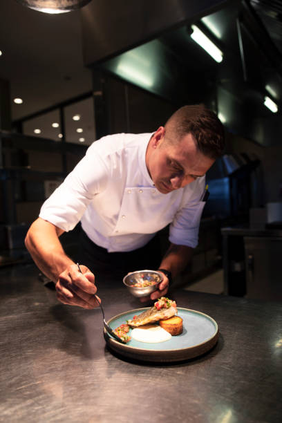 Male chef garnishing food