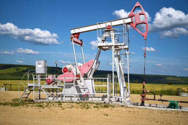 istock Oil pump, field, blue cloudy sky 1175790037