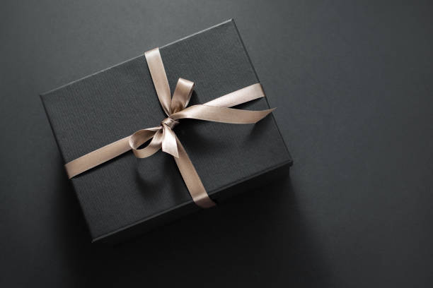 istock Gift wrapped in dark paper on dark background 1175792135