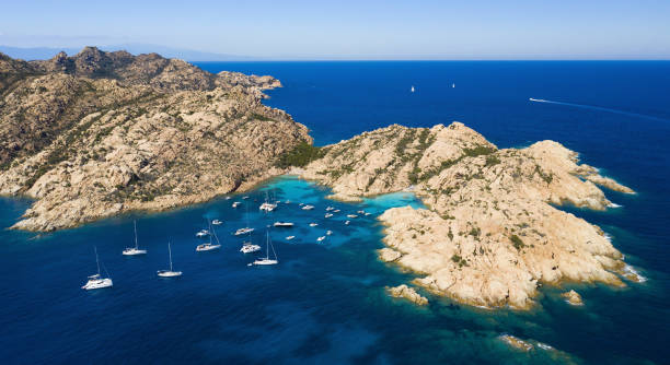 View from above, stunning aerial view of Cala Coticcio also known as Tahiti with boats and yachts floating on a turquoise clear water. La Maddalena Archipelago, Sardinia, Italy. View from above, stunning aerial view of Cala Coticcio also known as Tahiti with boats and yachts floating on a turquoise clear water. La Maddalena Archipelago, Sardinia, Italy. marine reserve photos stock pictures, royalty-free photos & images