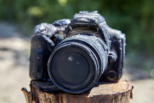 As a result of a forest fire, the camera of hiking tourists burned down, it was charred, smoked, and melted. Wildfire destroyed the photo equipment.