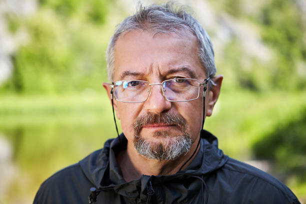 Serious mature man with glasses.