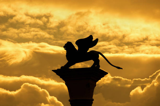 Saint Mark Winged Lion, symbol of the old Venice Republic, old medieval statue among golden clouds