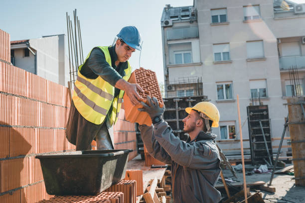 istock Construction Workers are Building a Brick Wall at the Rooftop of the Building 1175794741