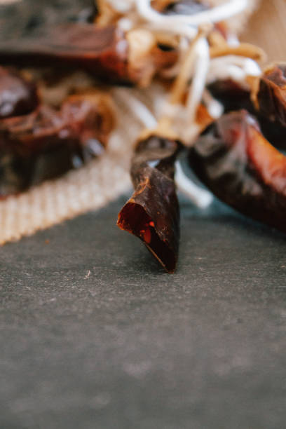 istock Hot chilli pepper on black background with rustic cloth, vintage tablecloth. Spicy traditional with copyspace. 1175795701