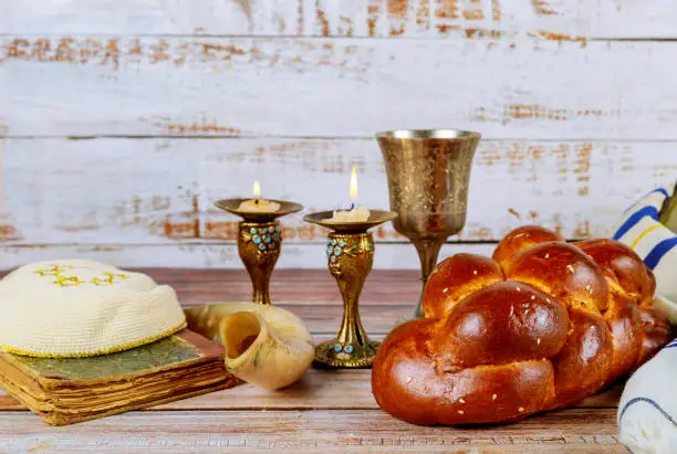 Shabbat challah bread, shabbat wine and candles on the table Jewish Holiday