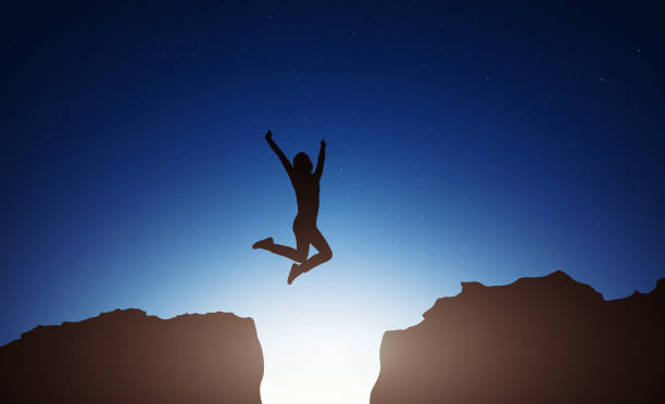 istock Happy woman jumping against night sky 1175798566