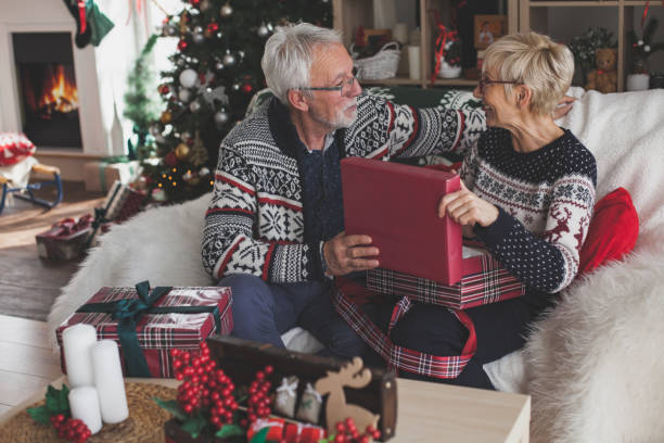 istock Wife opening a Christmas gift from her husband 1175802512