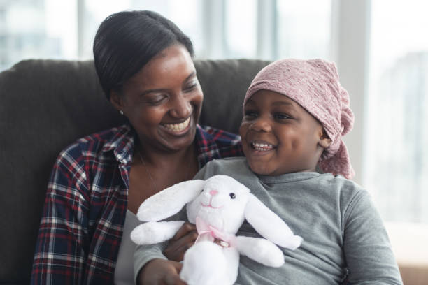 istock Supportive mother holds child with cancer 1175802789
