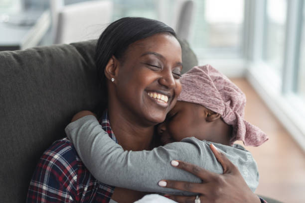 istock Supportive mother holds child with cancer 1175802790