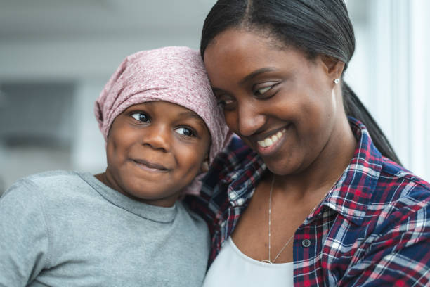 istock Supportive mother holds child with cancer 1175802800