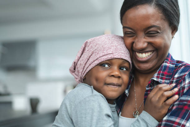 istock Supportive mother holds child with cancer 1175802803