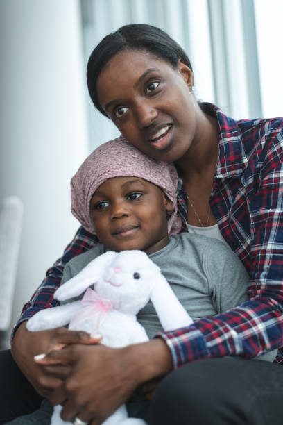istock Supportive mother holds child with cancer 1175802804