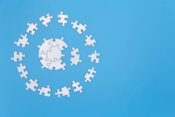istock White jigsaw puzzle pieces on a blue background. Problem solving concepts. Texture photo with copy space for text 1175811091