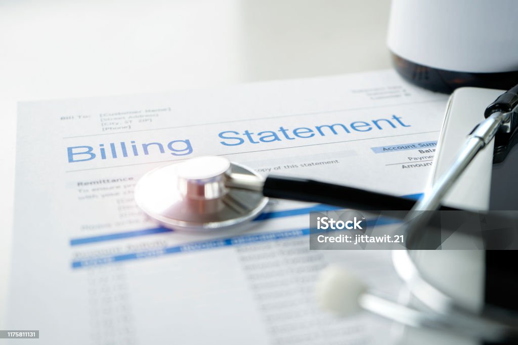 Health care billing statement. Health care billing statement with stethoscope, bottle of medicine for doctor's work in medical center stone background. Healthcare And Medicine Stock Photo