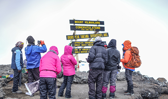 Kilimanjaro, Tanzania - January 23, 2019: Trekkers Successfully Climbing Mount Kilimanjaro at Uhuru Peak 5895 M , Kilimanjaro National Park