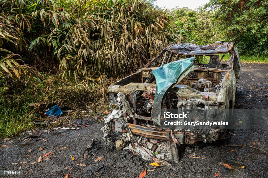 Abandond Burnt Car Abandoned burnt car on the Hana Hwy close to Pua’a Ka’a Falls, Maui, Hawaii Abandoned Stock Photo