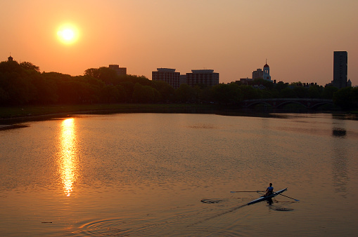 Cambridge,. MA, USA May 15, 2007 A lone sculler plies the Charles River in Cambridge, Massachusetts at sunrise