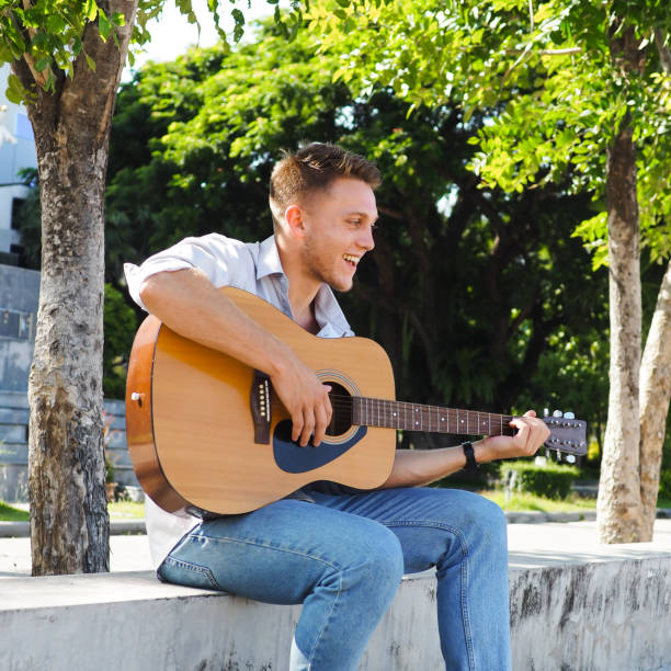 istock Campus student playing guitar outdoor, lifestyle concept. 1175821529