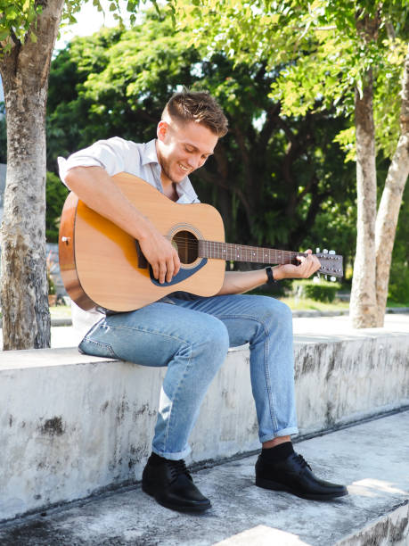 istock Campus student playing guitar outdoor, lifestyle concept. 1175821530