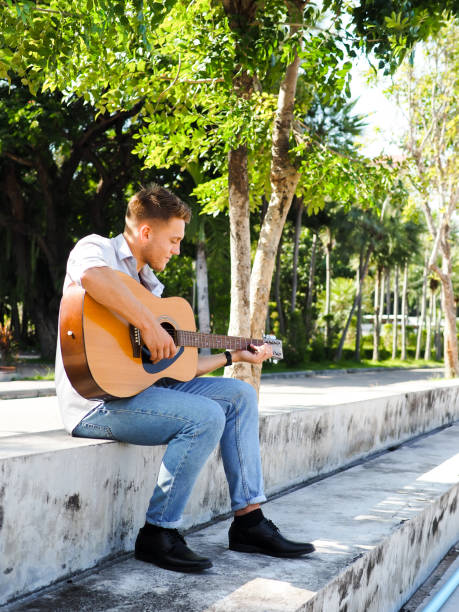 istock Campus student playing guitar outdoor, lifestyle concept. 1175821541