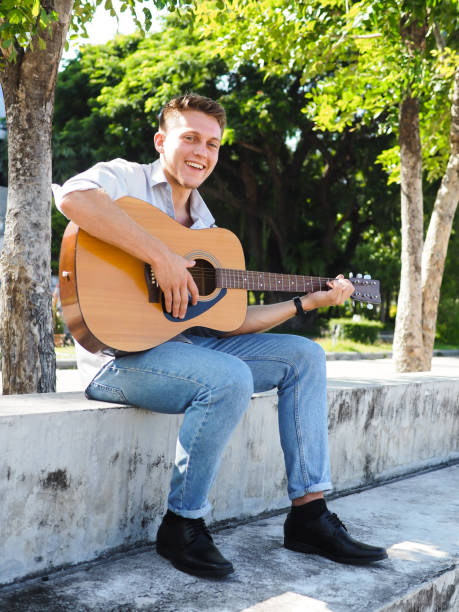 istock Campus student playing guitar outdoor, lifestyle concept. 1175822135