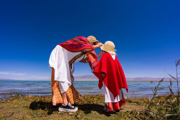 istock mother and daughter by the lake side 1175822220