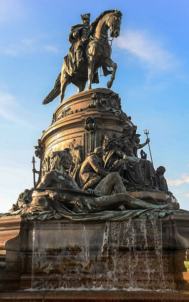 The Washington Monument at Eakins Oval in Philadelphia, PA A picture of an equestrian statue of George Washington atop a water fountain in Washington Monument at Eakins Oval, at the end of Benjamin Franklin Parkway in Philadelphia, PA. This monument is located in front of the Philadelphia Museum of Art and it was designed by Rudolph Siemering and dedicated in 1897. benjamin franklin parkway photos stock pictures, royalty-free photos & images