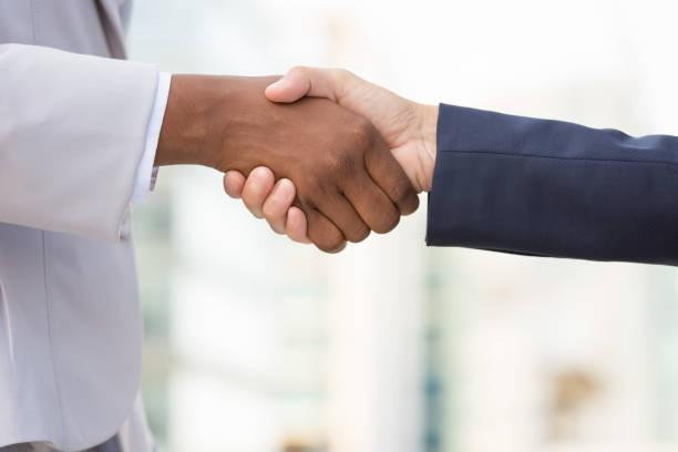istock Diverse female business leaders shaking hands 1175823620