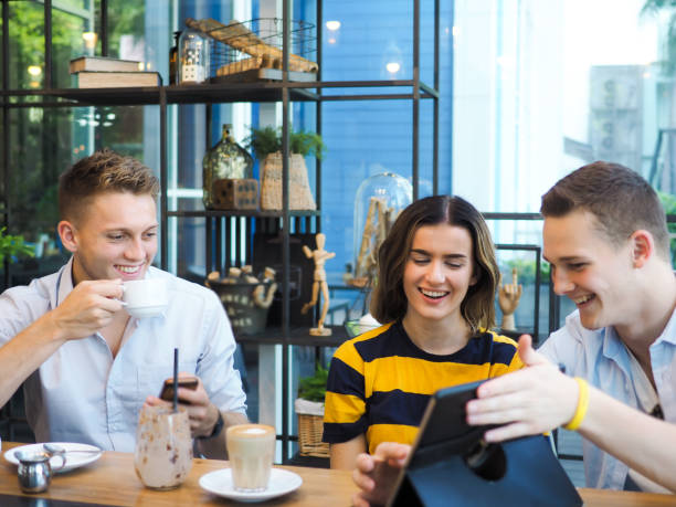 istock Smart man and woman using tablet and drinking coffee in cafe, lifestyle concept. 1175826422