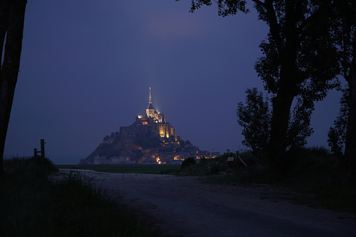 Dusk at Mont St Michel with illuminated cloud through an alley